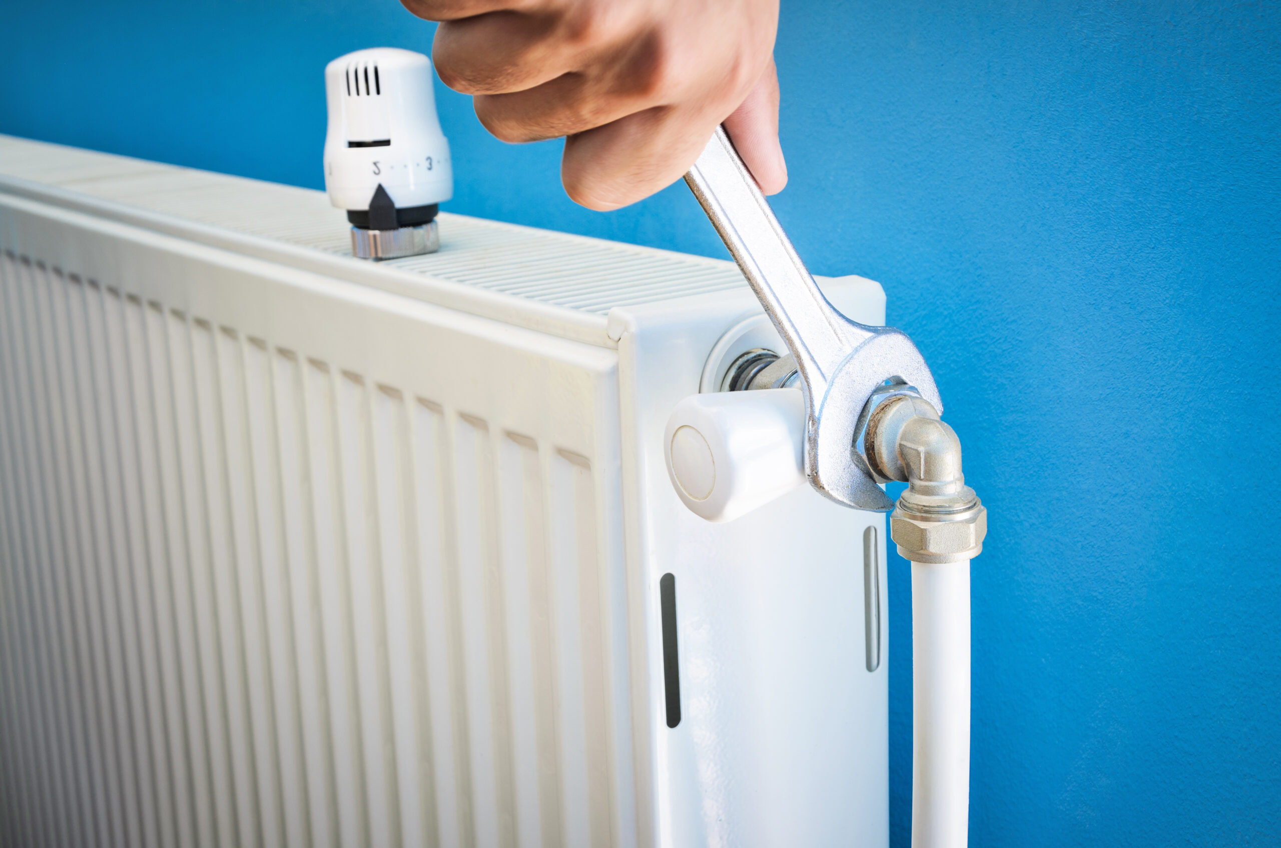 Man installing radiator valve close up